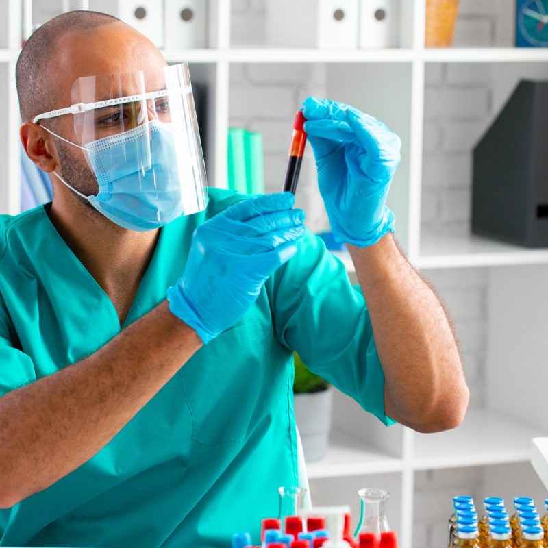African american doctor or laboratory worker examines blood sample in clinic African american doctor or laboratory worker examines blood sample in clinic