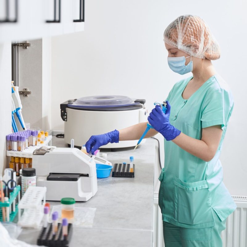 Female in medical suit working in laboratory